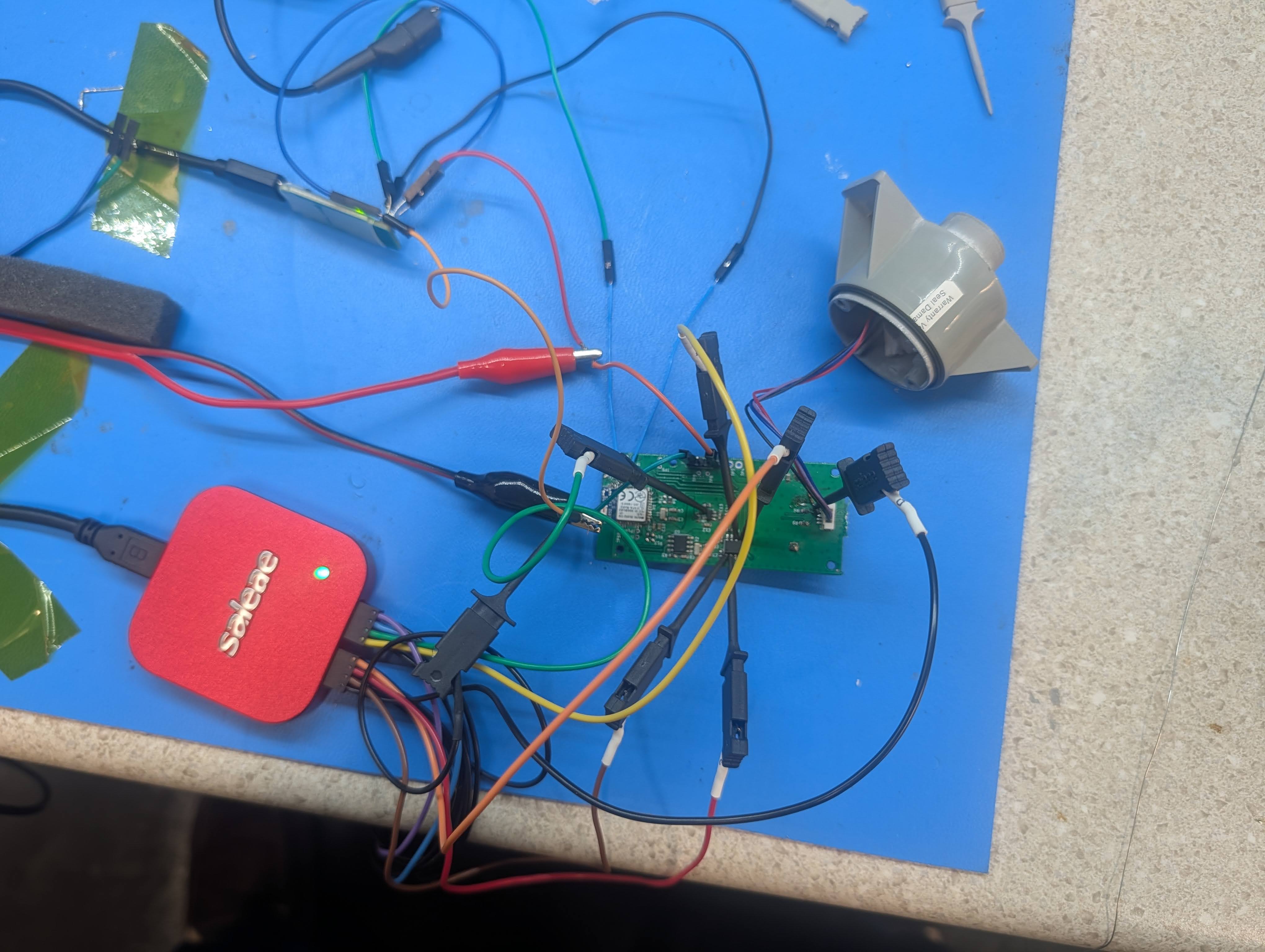 The Saleae logic analyzer and J-Link connected to the board during development. Notice that the ToF board has been disconnected from the main board and is now using the wire harness for data transfer.